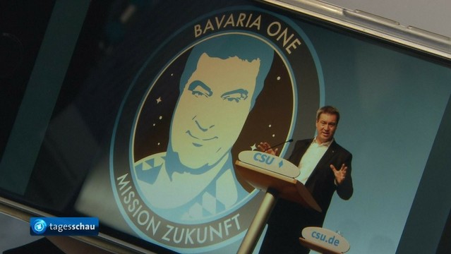 Söder stellt das Weltraumkonzept Bavaria One vor mit seinem Konterfei