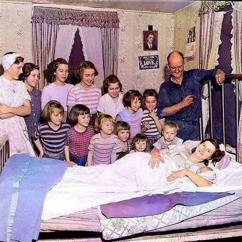 Thirteen sisters in the Brooks family view their only brother Leslie Benjamin, following his birth at home in Pittsfield, Massachusetts (1954)