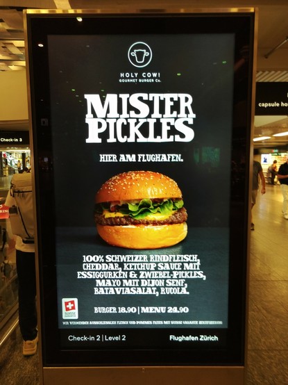Werbung der Burgerkette Holy Cow, welche für einen Burger namens Mister Pickles wirbt.