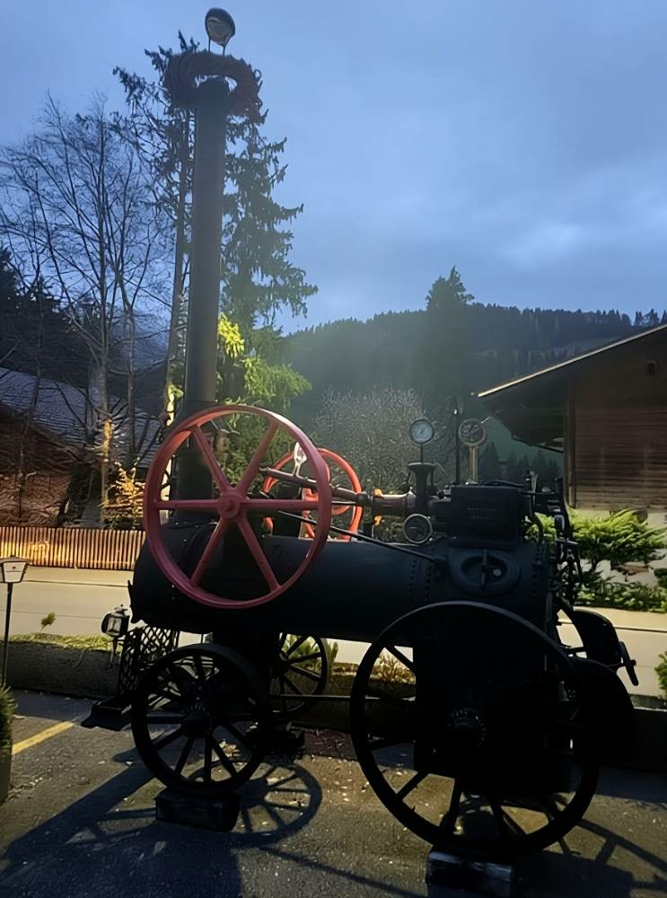 Eine alte Dampfmaschine im Laternenlicht.
