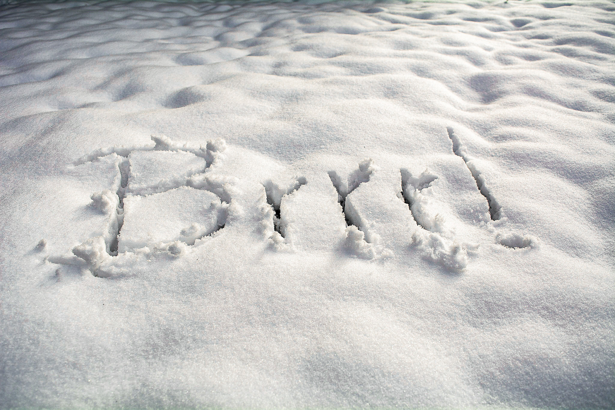 Der Hauptteil des Bildes zeigt ein Foto von Schnee. In den Schnee ist das Wort "Brrr!" geschrieben