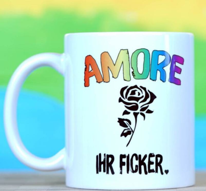 Eine weiße Tasse mit einer Rose, "Amore" in den Farben des Regenbogens. Darunter in wilder Schrift "IHR FICKER"